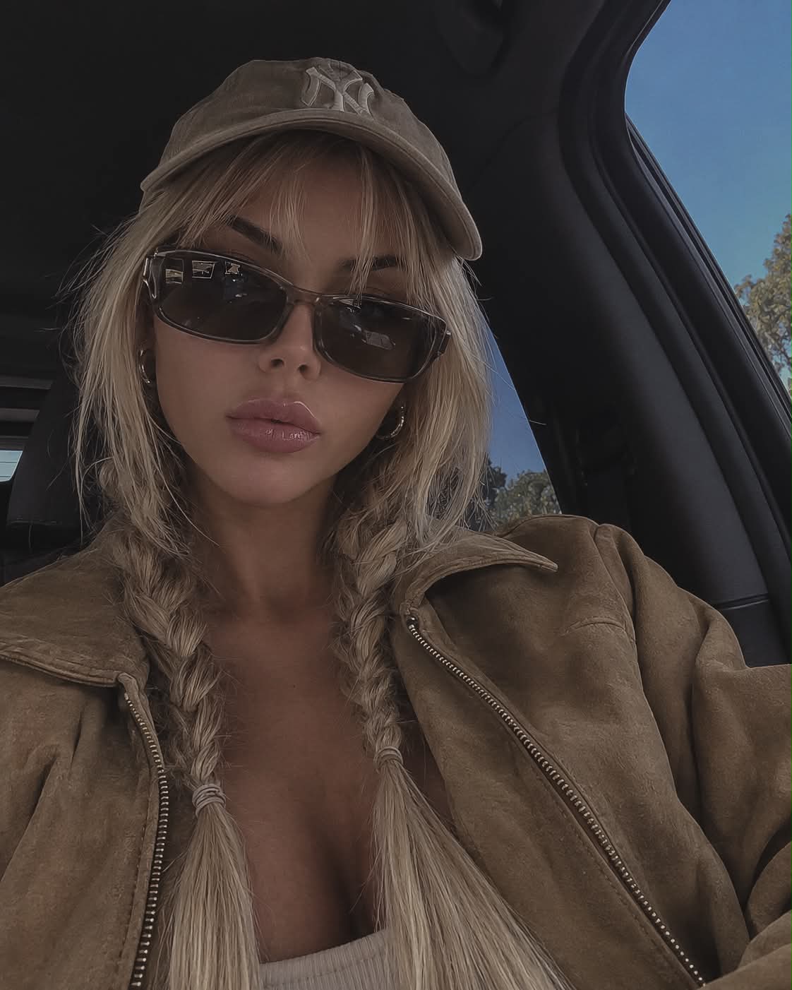 Low-Angle Car Selfie of a Woman in a Suede Jacket
