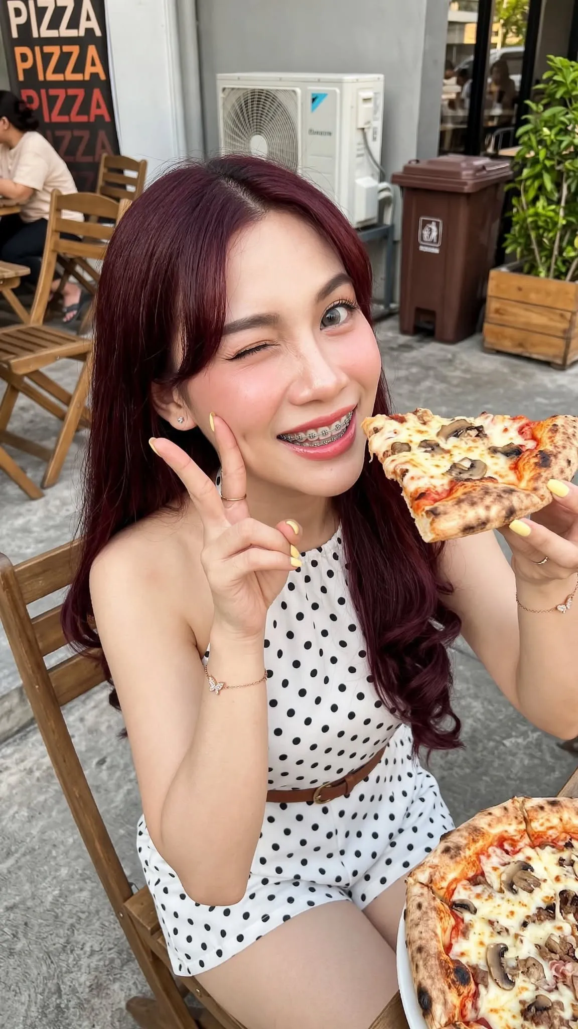 Young Woman Eating Pizza at an Outdoor Restaurant output 2