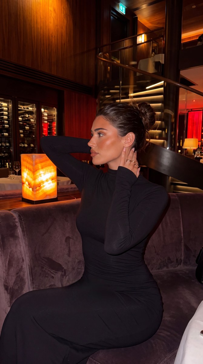 Woman in a Warmly Lit Luxury Restaurant