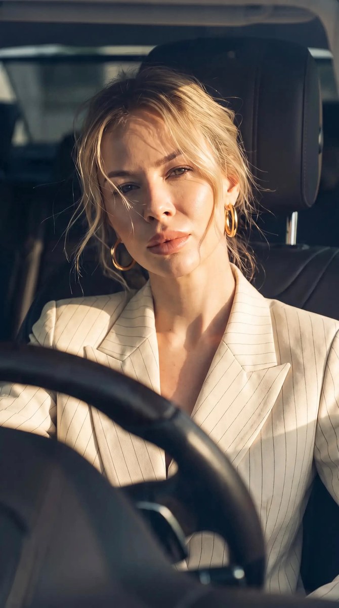 Confident Young Woman in a Luxury Car