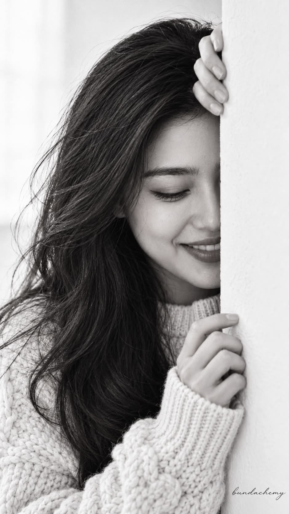 Candid Monochrome Portrait Peeking Around a Wall