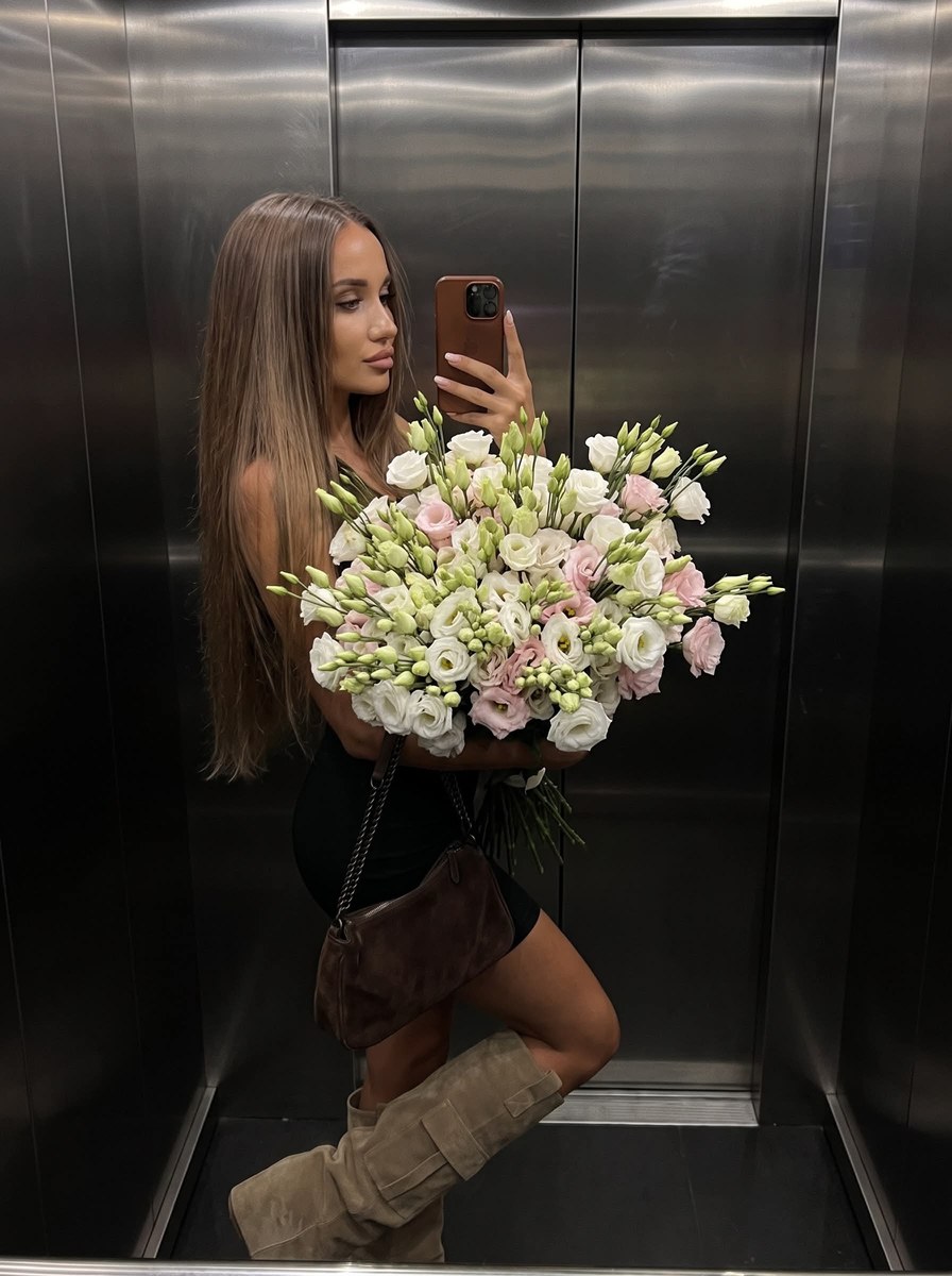 Moody Elevator Mirror Selfie with an Oversized Bouquet