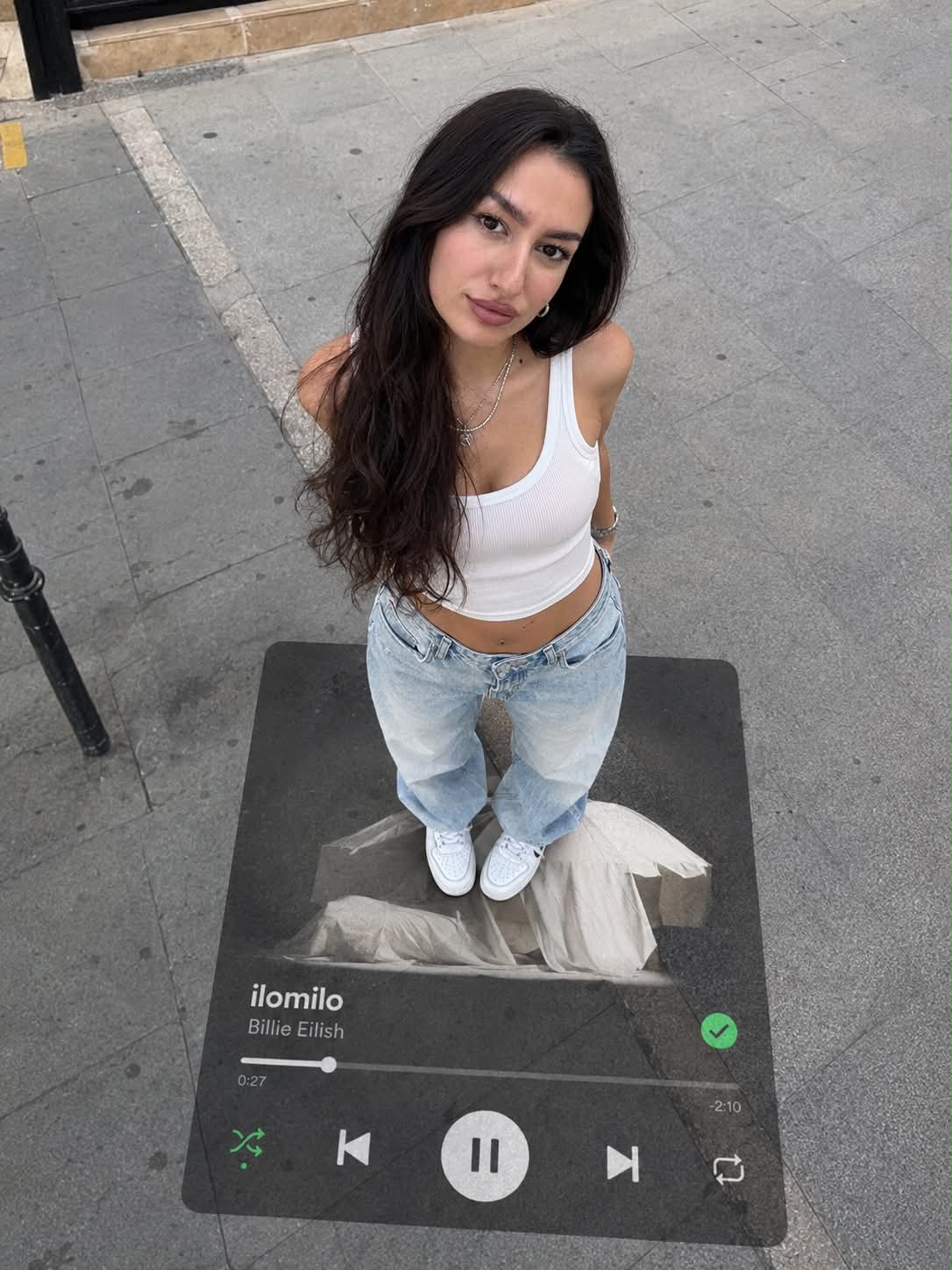 Overhead Sidewalk Portrait with Music Player Overlay