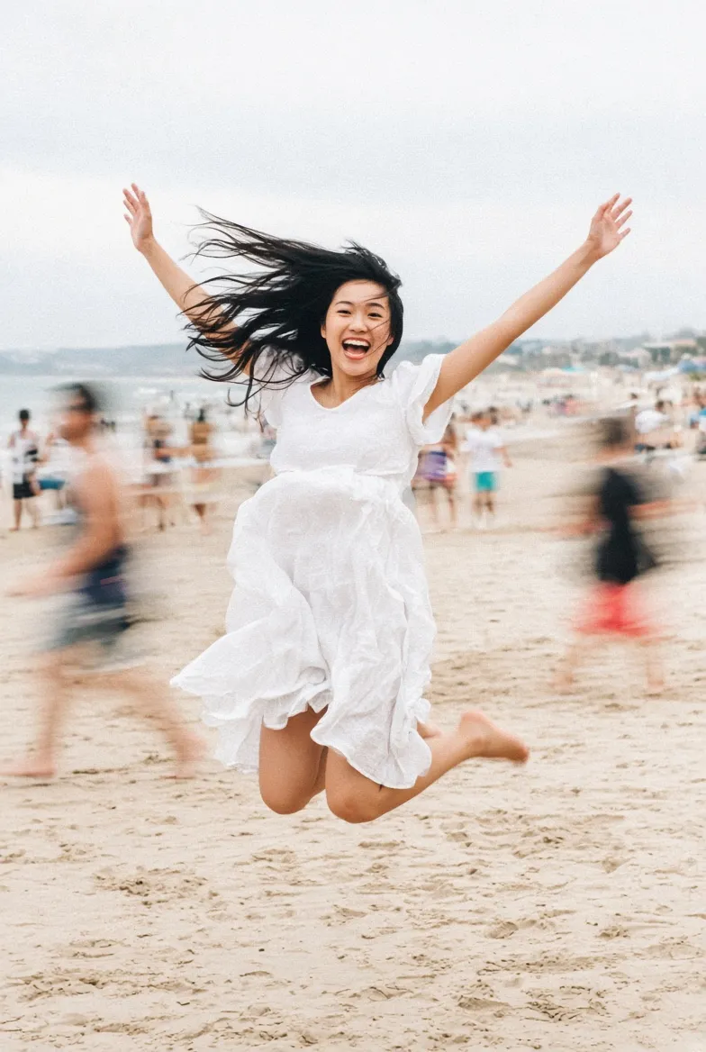 Joyful Beach Jump with a Candid Film Look