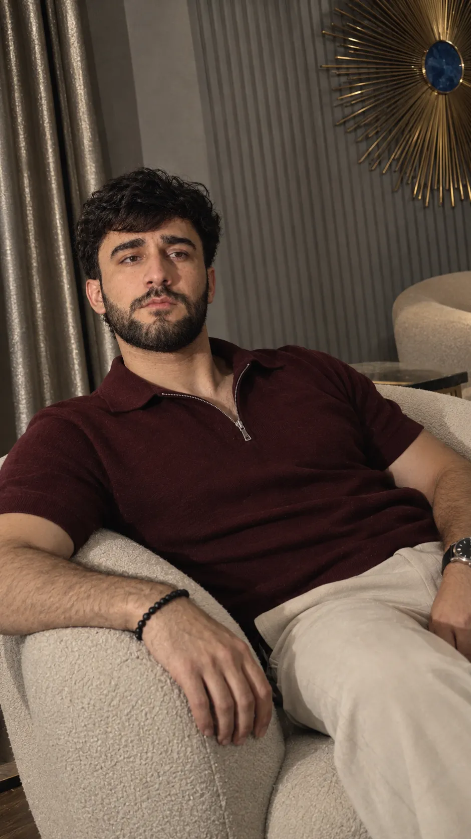 Moody Portrait in a Cream Bouclé Armchair