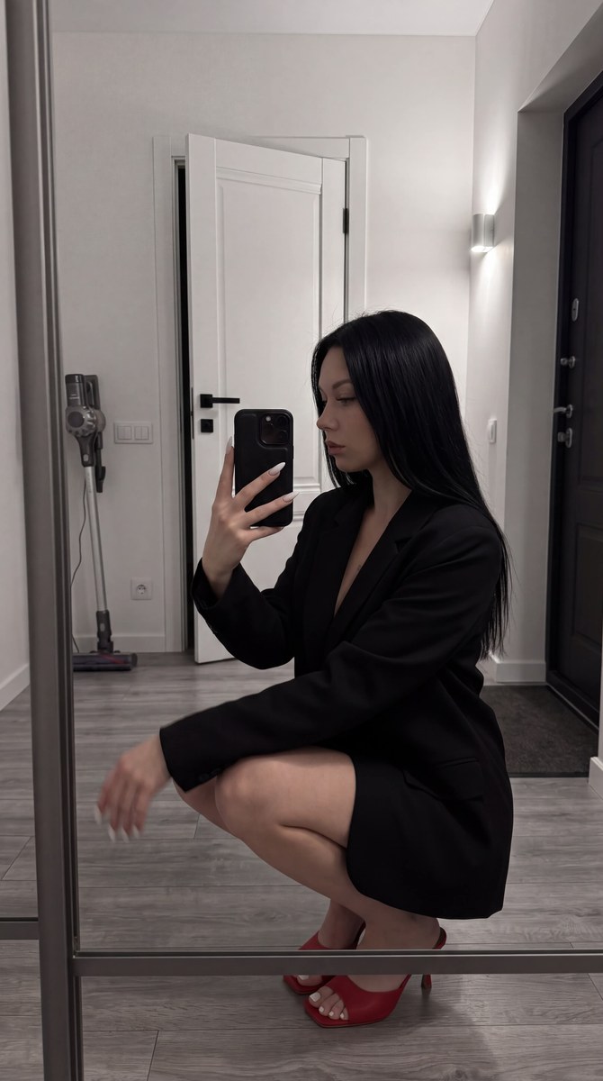 Dark Mirror Selfie in a White Hallway