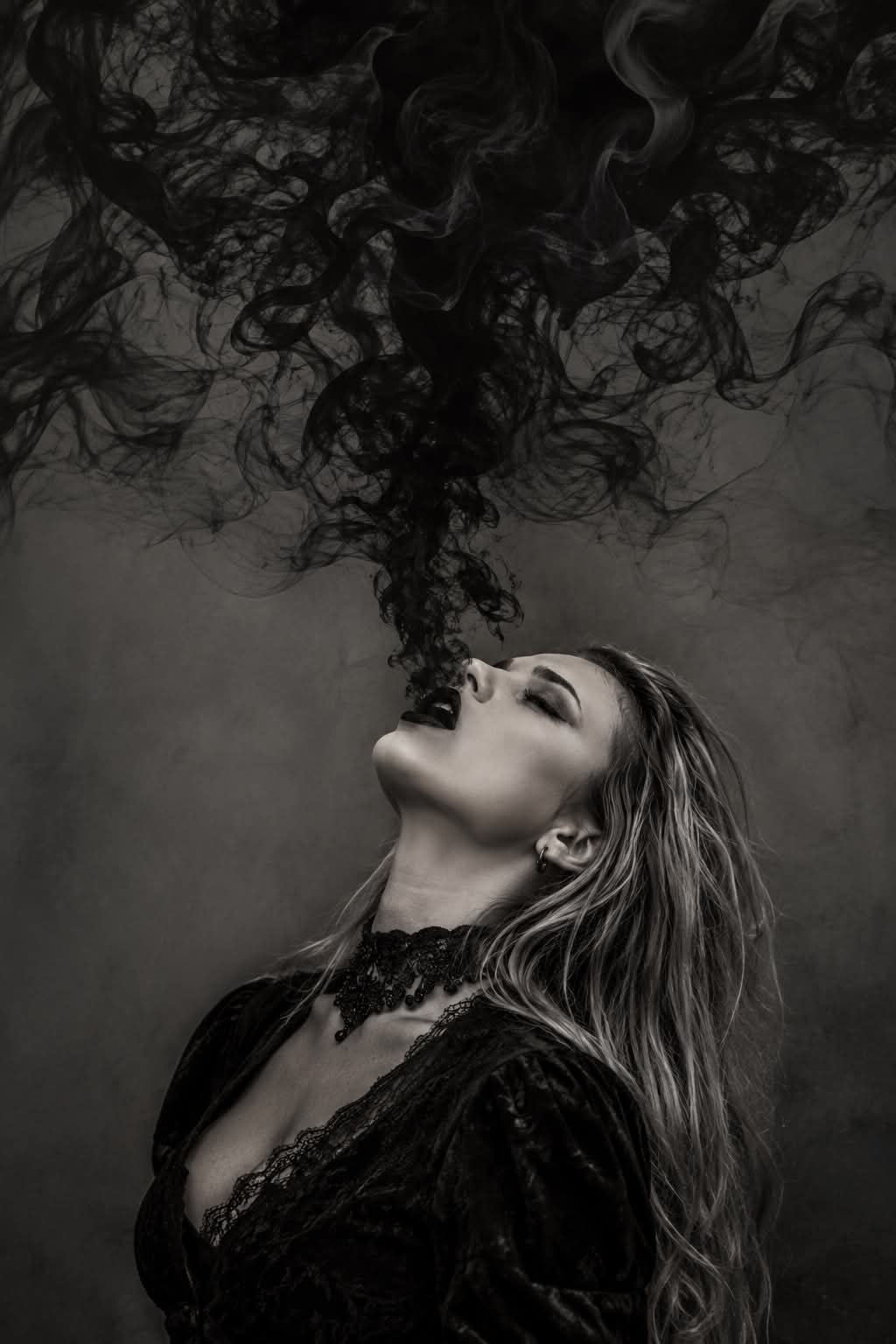 Monochrome Gothic Witch Portrait with Exhaled Smoke