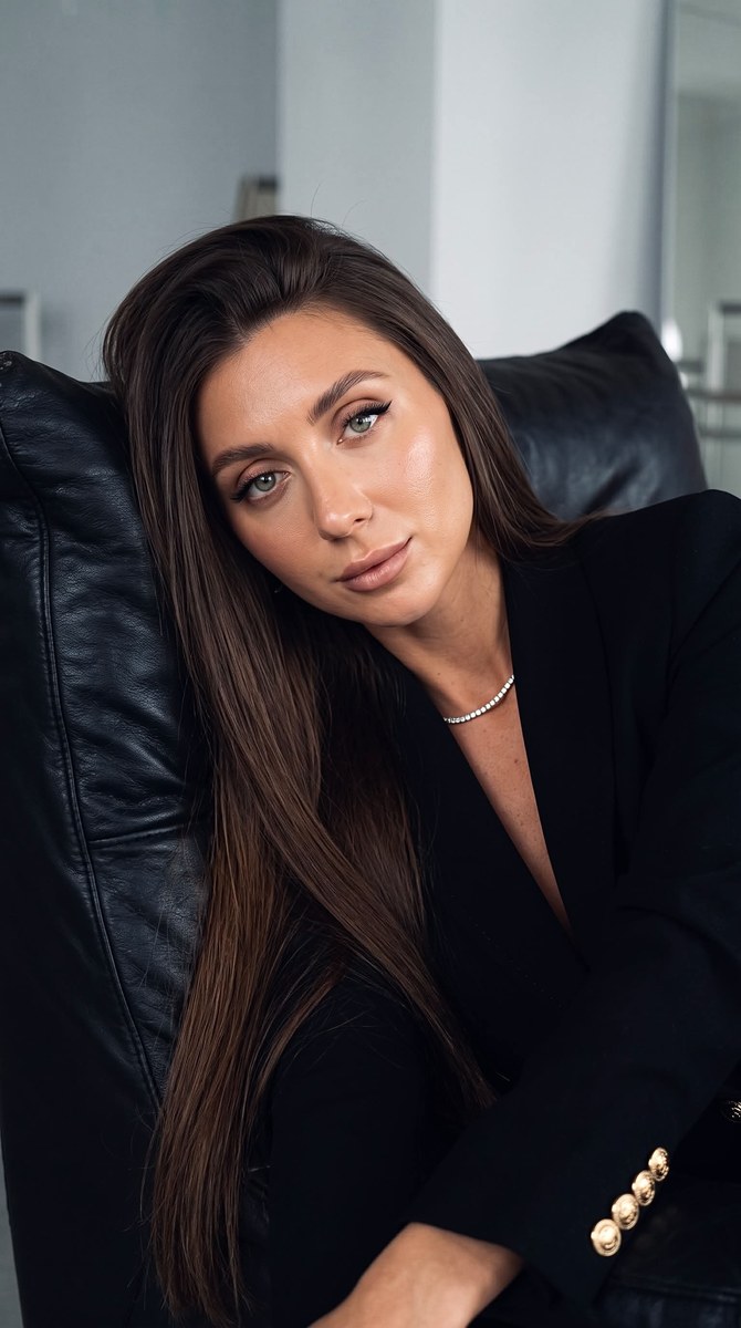 Photorealistic Portrait of a Woman in a Black Leather Chair