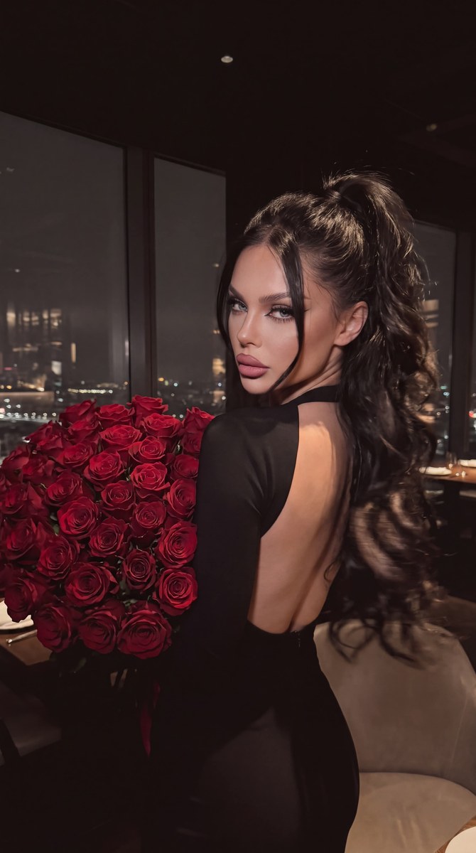 Low-Light Portrait with a Bouquet of Red Roses