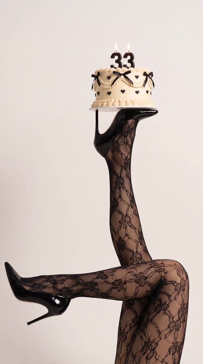 Studio Fashion Photo of Lace-Clad Legs and a Birthday Cake