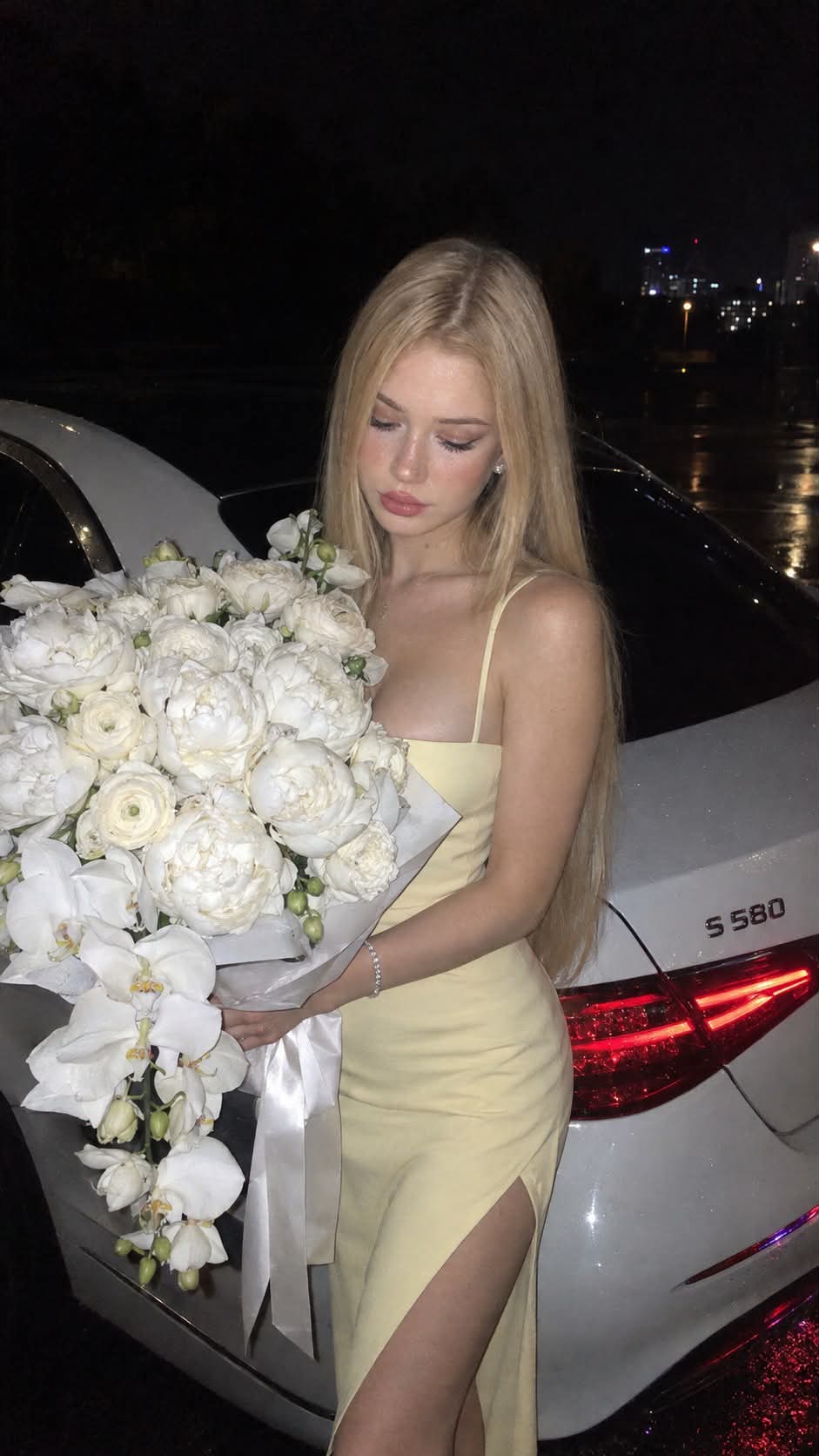 Flash Photo of a Woman with a White Flower Bouquet