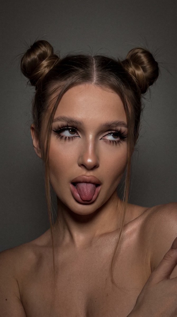 Dark, Playful iPhone Selfie with Double-Bun Hair