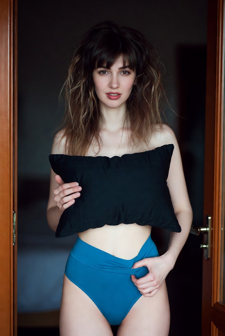 Pensive Woman in a Bedroom Doorway at Dawn