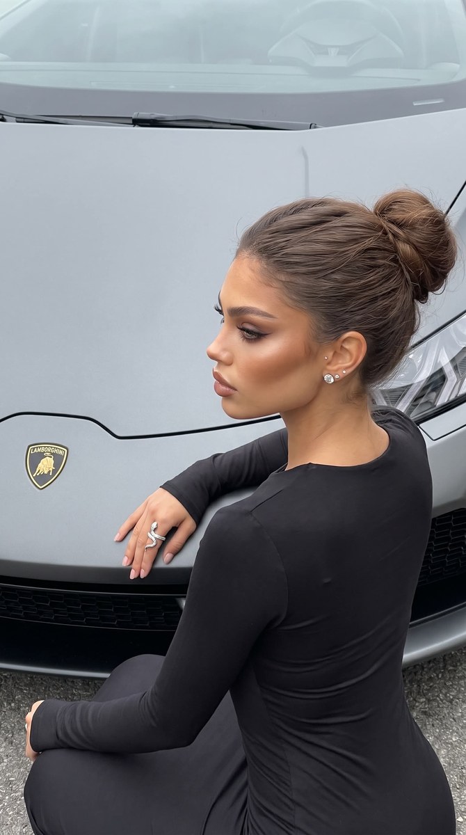 Young Woman Posing Beside a Lamborghini